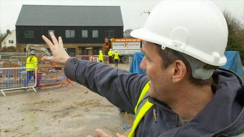 Man on housing construction site.