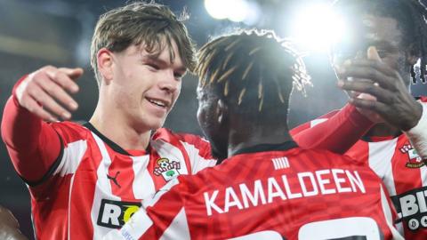 Tyler Dibling of Southampton celebrates with team-mates Kamaldeen Sulemana and Lesley Ugochukwu after his second goal against Swansea City