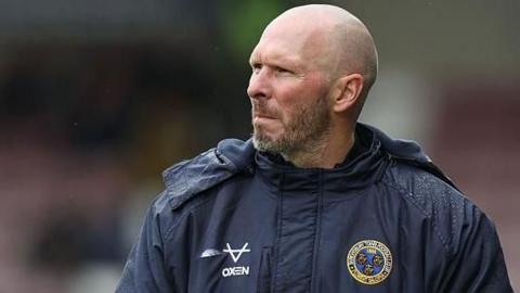 Michael Appleton wearing his Shrewsbury Town club jacket in the touchline