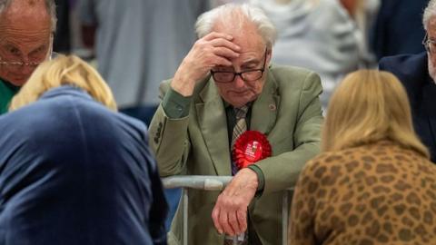 A Labour supporter looking at the vote count