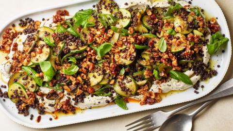 A large platter of caramelised courgettes with lentils and tahini yoghurt.