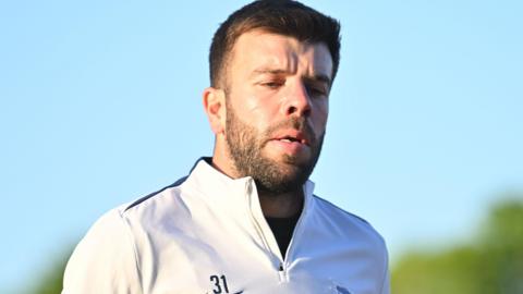 Grant Hanley training for Birmingham City while wearing a white tracksuit