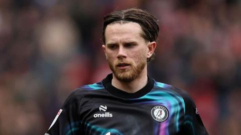 Max Bird wearing Bristol City away kit jogging on the pitch