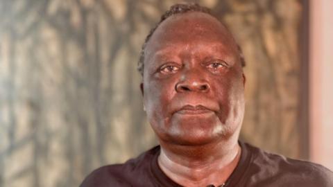 Suzgo Nyirenda stands in front of a painting at his home in Aylesford, Kent as he encourages black men to get checked for prostate cancer