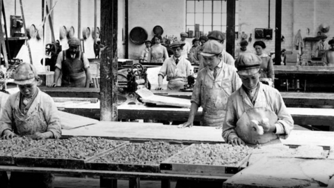 Factory staff are working in a sweet factory in Maidstone in a black and white archive photograph