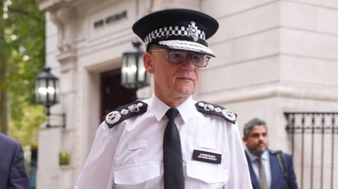 Metropolitan Police Commissioner Sir Mark Rowley wearing his uniform walks in central London