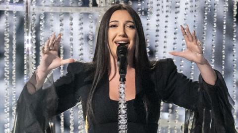 Yuval Raphael smiling as she takes part in the Eurovision Song Contest 
