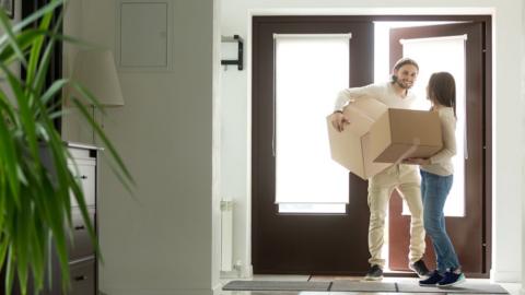 Young couple moving into home