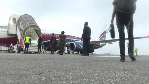 People queuing up to board a flight in Nigeria
