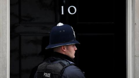 A police officer stands on duty outside 10 Downing Street, in London, on 30 March 2022