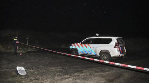 A Dutch police vehicle at the crime scene on Monday