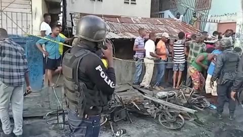 People stand at the site of an explosion in Cap-Haitien, Haiti December 14, 2021, in this still image obtained from Reuters TV footage.