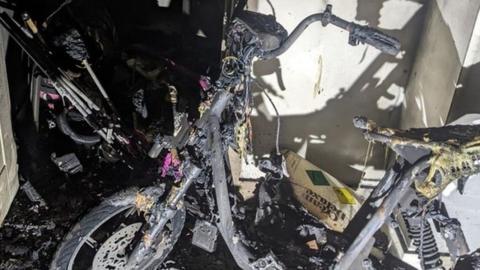The charred remains of an e-bike after a fire in Kingston