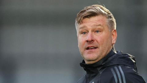 Salford City boss Karl Robinson looks on