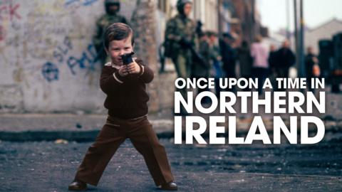 Child pointing a gun during the troubles