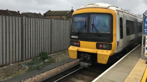 A Southeastern class 466 train leaving a station