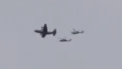 A still of a video showing what appears to be a US plane accompanied by two helicopters flying over southern Iran