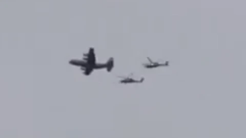 A still of a video showing what appears to be a US plane accompanied by two helicopters flying over southern Iran