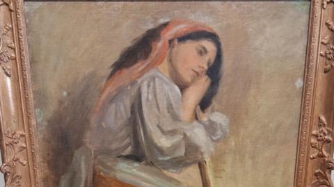 A painting believed to be by artist Stanhope Alexander Forbes. It shows a woman sat on a stool leaning on a broom.