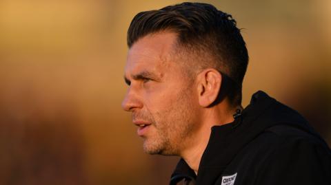 A close up of Matt Bloomfield wearing a black Oxford United jacket in April