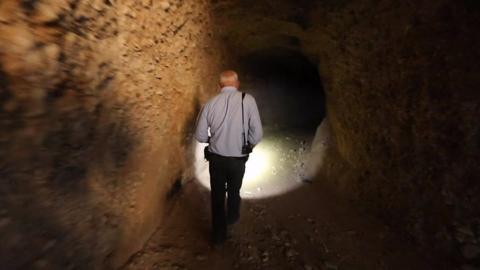 Jeremy Bowen inside a tunnel