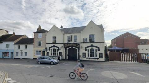 View of the Steam Railway Pub with road and mini roundabout in front