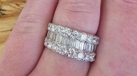 A picture of the ring that was stolen. It is a large ring with a number of diamonds in it and silver in colour.