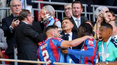 John Textor annd Steve Parish hold the FA Cup with Crystal Palace's players