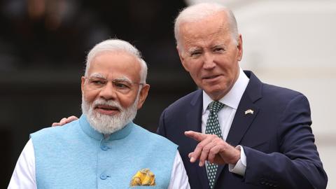 President Joe Biden and Indian Prime Minister Narendra Modi talk during an arrival ceremony at the White House