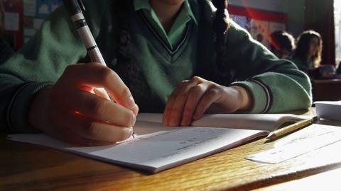 School girls writing on paper