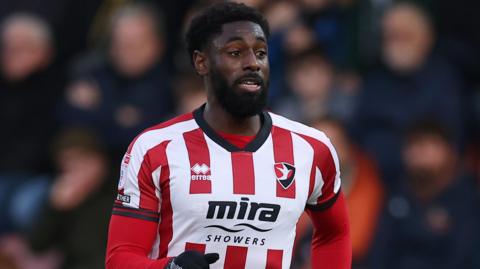 Hakeeb Adelakun in action for Cheltenham Town