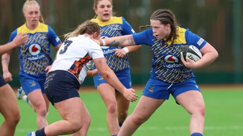 Gwalia Lightning's Maisie Davies fends off a challenge in the win over Edinburgh