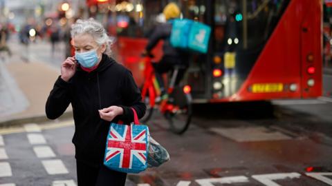 A woman is pictured on Oxford Street in London