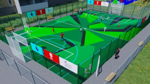 A computer-generated image of what the pitch is expected to look like. The colours are primary and bright and there are figures playing on the pitch, which is surrounded with fencing.