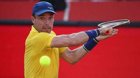 Roberto Bautista Agut hits the ball