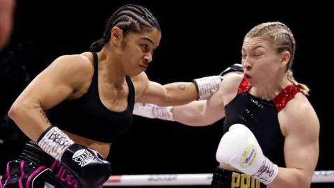 Jessica McCaskill attempts to punch Lauren Price during their IBO and WBA World Welterweight title fight 