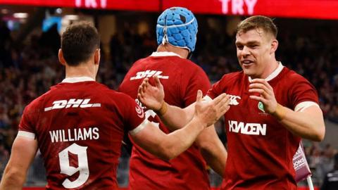 Lions players celebrate a try