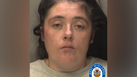 A police mugshot of Laura Shanley in a light grey t-shirt