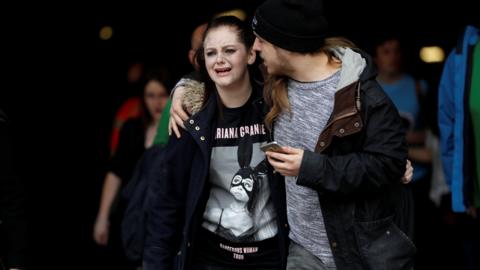 A victim crying and being comforted after the Manchester attack