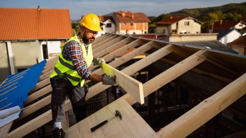 Worker building a house