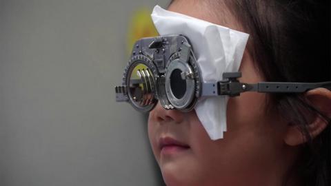 A young girl in Singapore taking an eye test