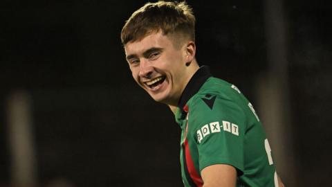 Jonny Russell smiling while looking to his left during a match 