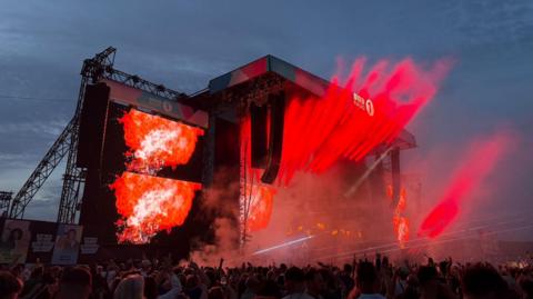 Lights fill the stage as Fatboy Slim plays his set