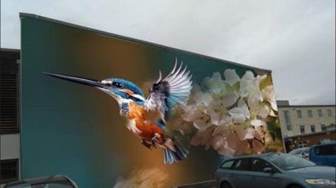An artists impression of a large blue and orange kingfisher bird on the side of a wall in a car park