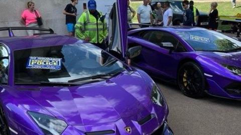 Two purple Lamborghinis, each with a sign that reads: "Seized by Police" on the windscreen.