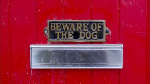 Postbox with beware of the dog sign