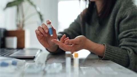 File picture of someone doing a finger prick blood test at home