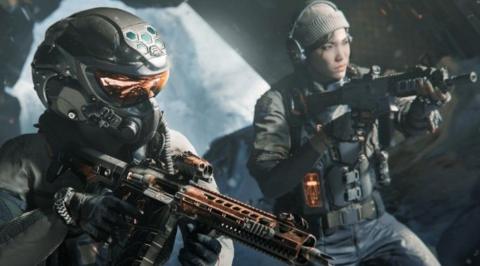 An in-game screenshot from the game. A person in a helmet with orange reflective visors, holds an orange and black gun, a woman behind them with a beanie hat on and headphones is also pointing a gun off screen.