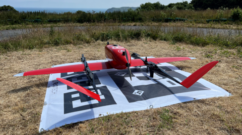 red drone on grass 