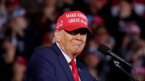 Republican presidential nominee and former U.S. President Donald Trump reacts during a rally in Juneau, Wisconsin,